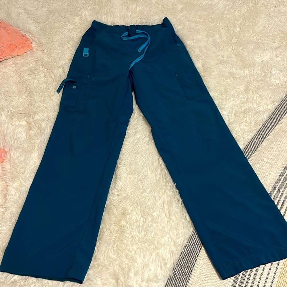 Size extra small regular length Carhartt scrub bottoms in Caribbean blue.